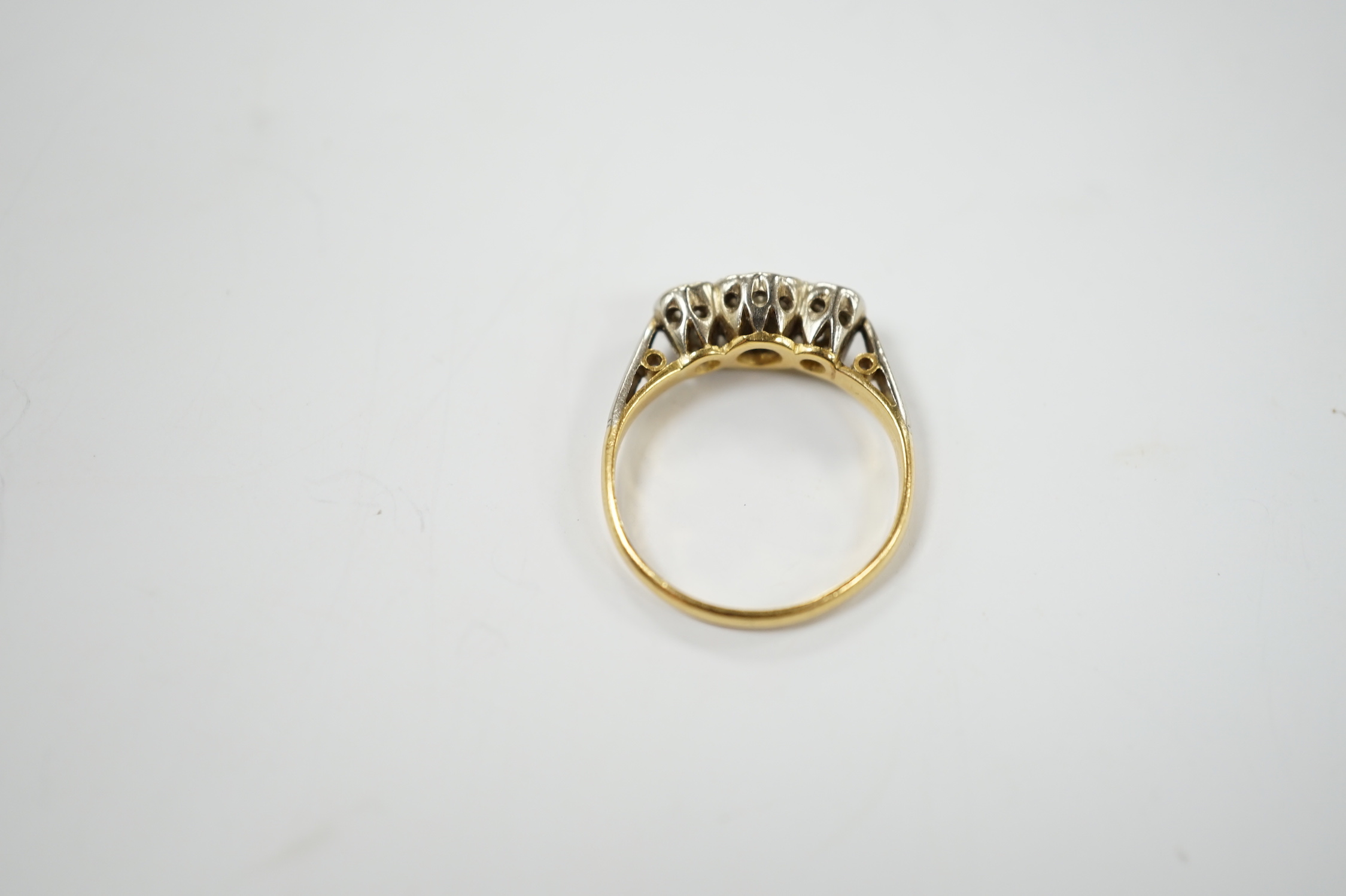 An 18ct, plat and illusion set three stone diamond ring, size J/K, gross weight 2.6 grams.